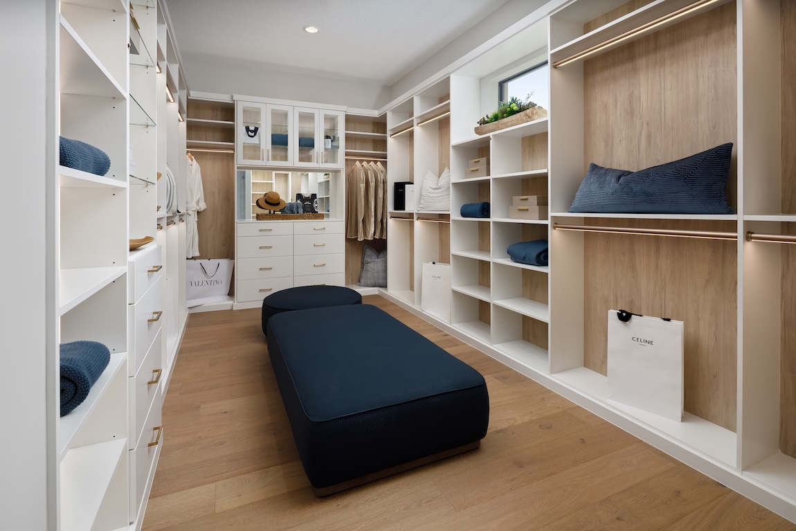 closet with a lot of storage space and seating