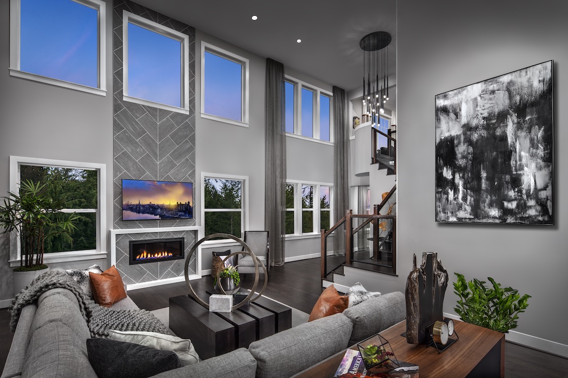 Great room with fireplace, many windows and gray color scheme.