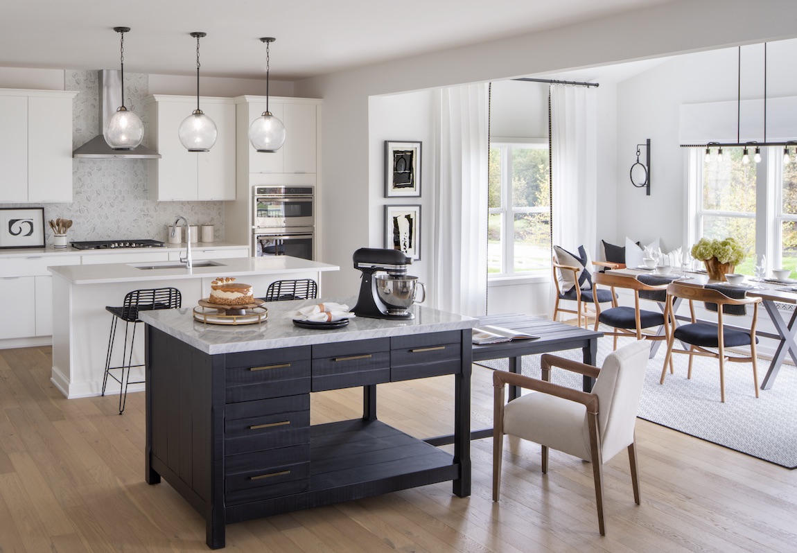 Kitchen with blue island and natural lighting.
