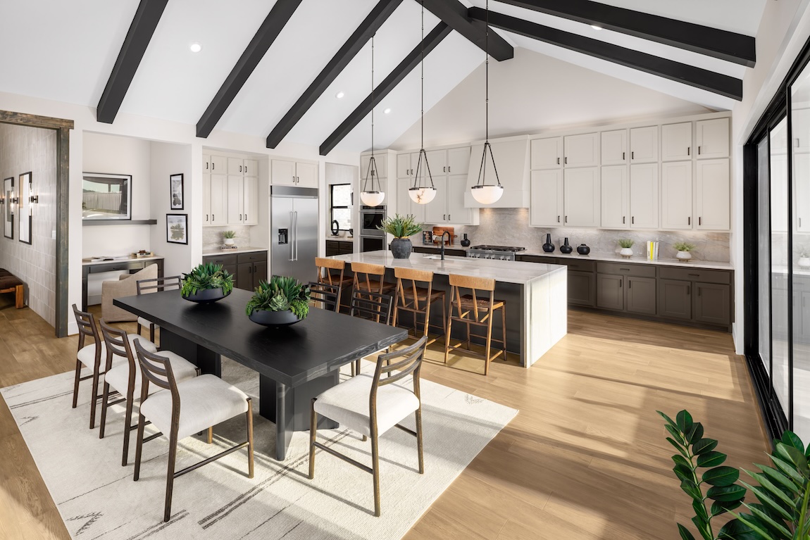 Modern farmhouse kitchen and dining space with a wood beamed ceiling.
