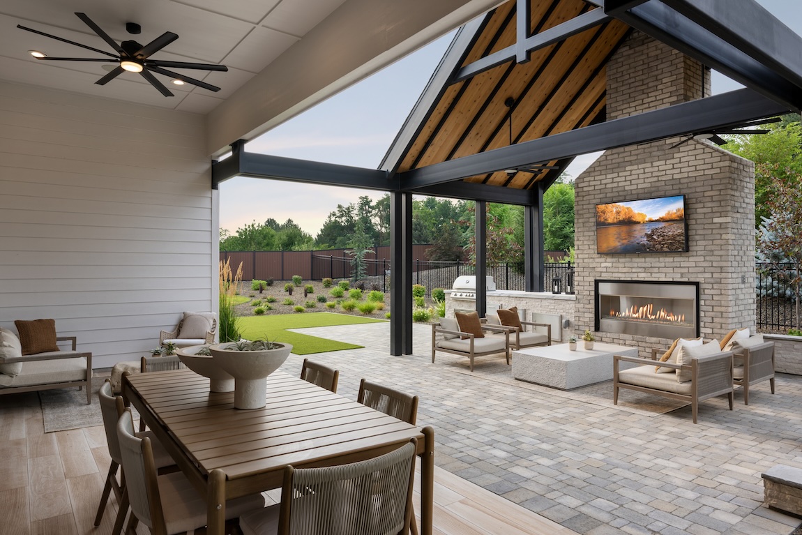 Backyard retreat with dining area, lounge seating, fireplace, and outdoor kitchen.