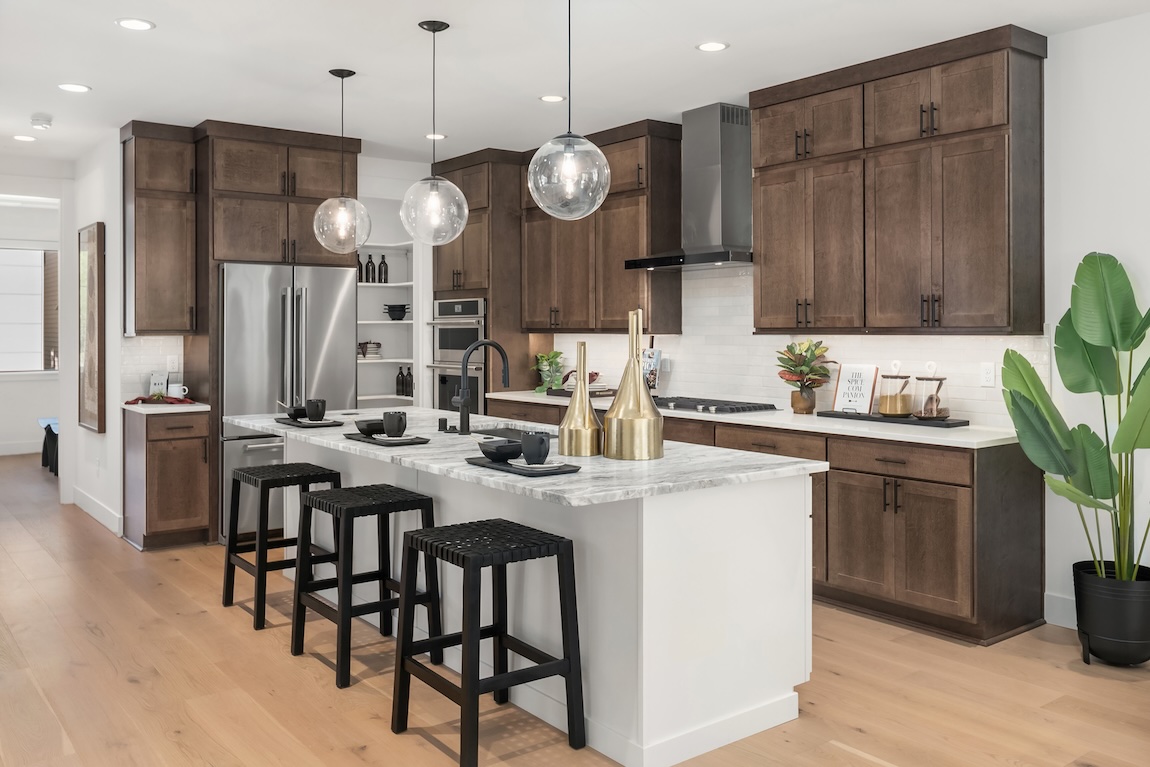 modern kitchen with wooden cabinets and a marble island