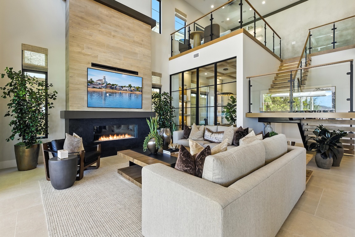 modern great room with fireplace and access to the second floor