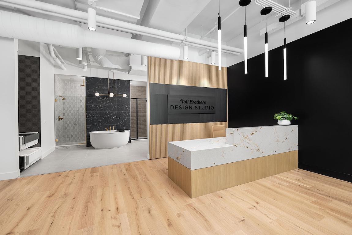 Tennessee Toll Brothers Design Studio reception area with luxury bath displays, modern lighting, and wood accents.