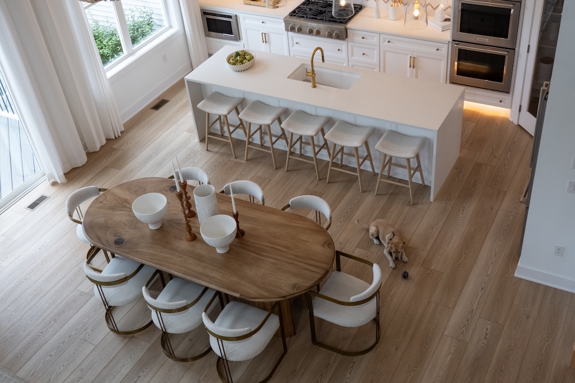 modern open-concept kitchen and dining space with dog on the floor