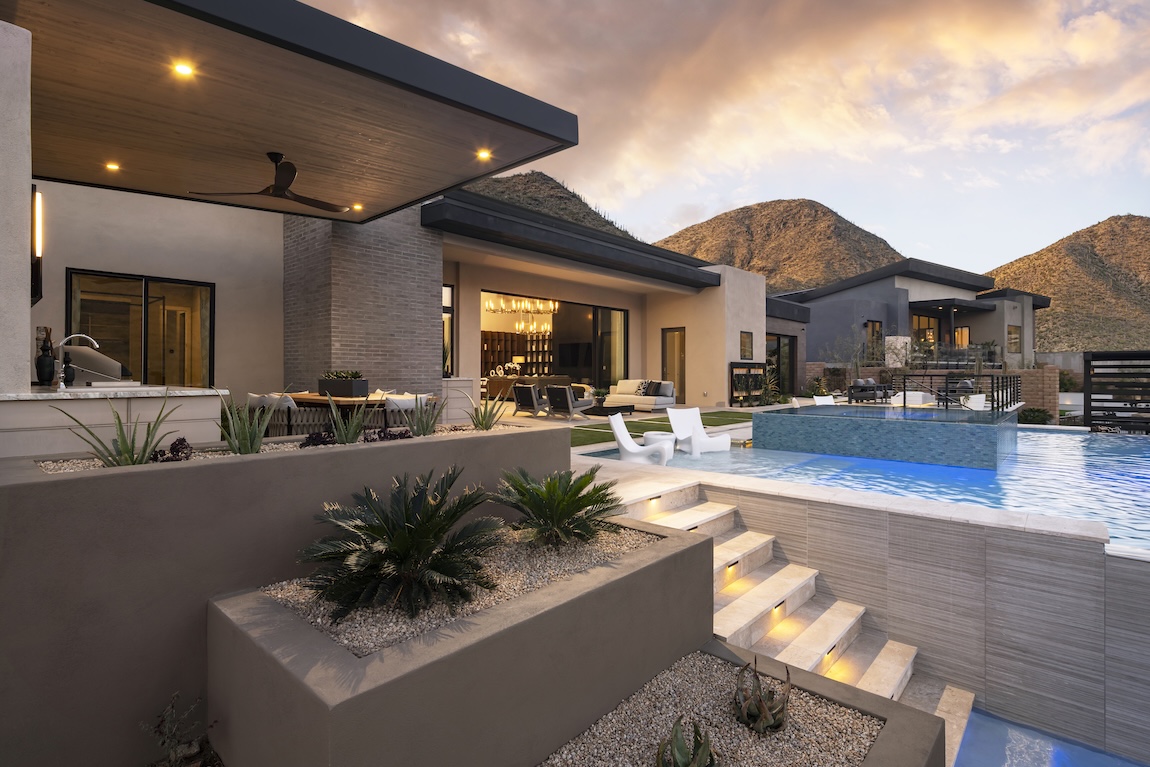 luxury backyard pool with toe-kick lighting on the stairs