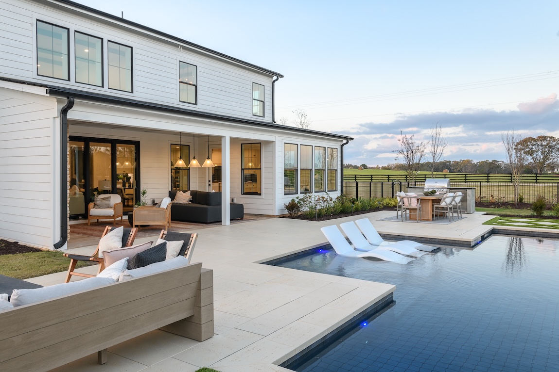 backyard pool with lounge seating and grill area