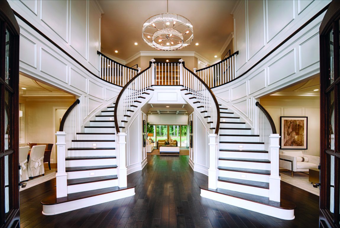 Entry highlighted by imperial staircase and gorgeous chandelier.