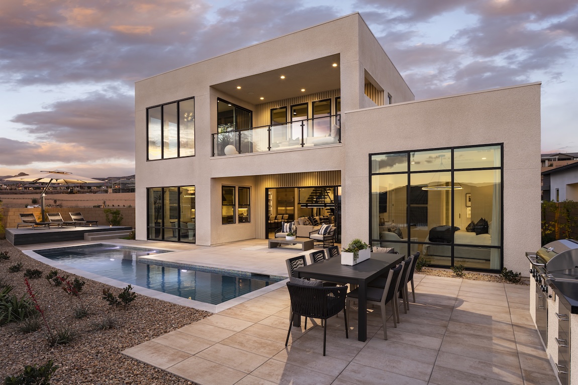 exterior of home with second story patio overlooking the pool