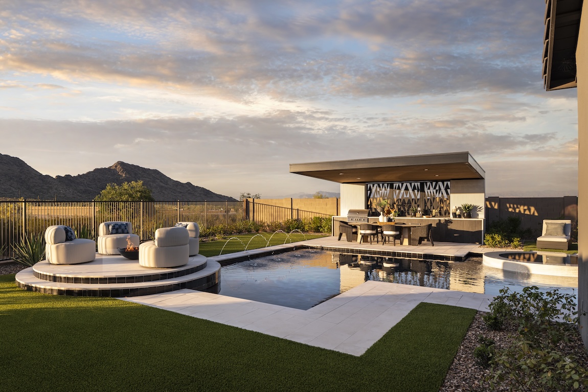 outdoor pool with seating areas and a mountain view
