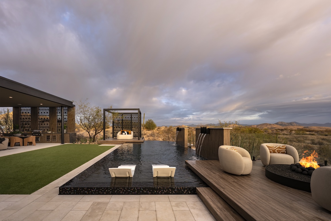 outdoor pool and lounge spaces with a fire pit