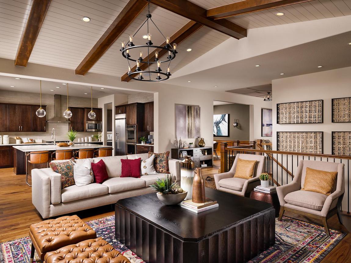 Family room with wooden beamed ceilings and red accent pillows.