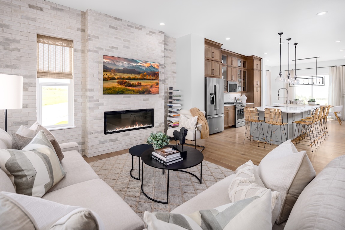 modern farmhouse design in living room with open concept floor plan leading to the dining and kitchen area