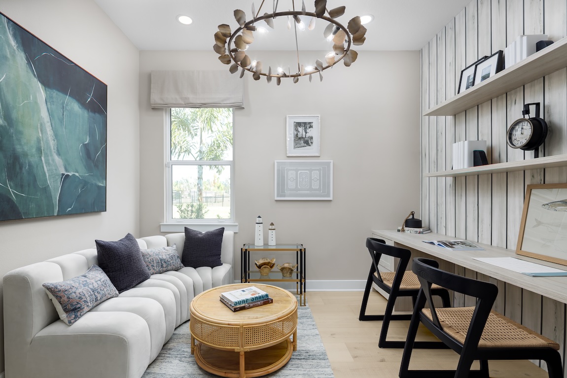 flex room with desk space and plush couch