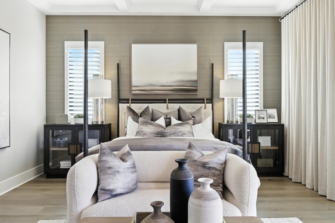 primary bedroom with textured accent wall and gray colors throughout