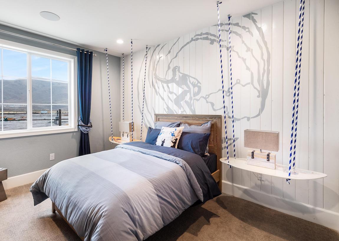 Teen bedroom with surfing theme highlighted by dual suspended nightstands
