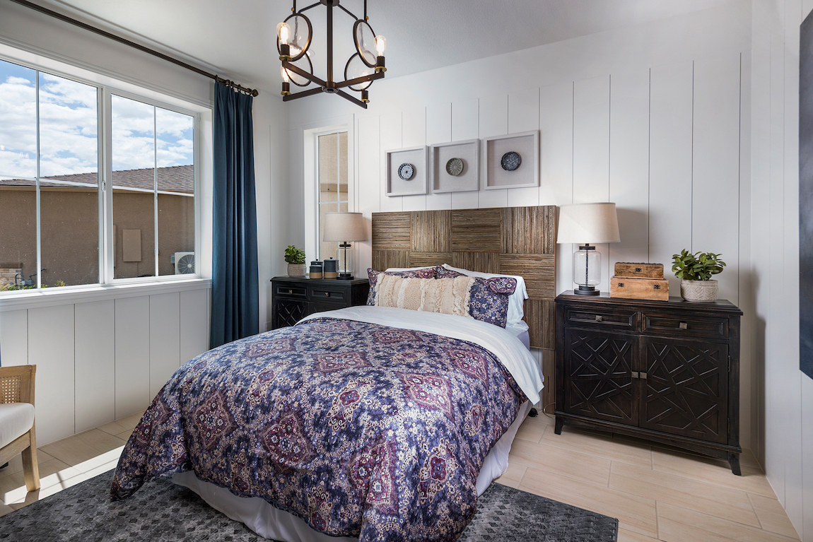 Teen bedroom featuring wooden headboard and three-wide picture frames above
