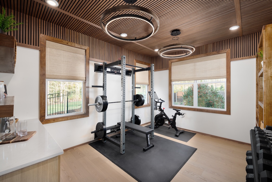 at home gym with weight lifting equipment and Peloton bike