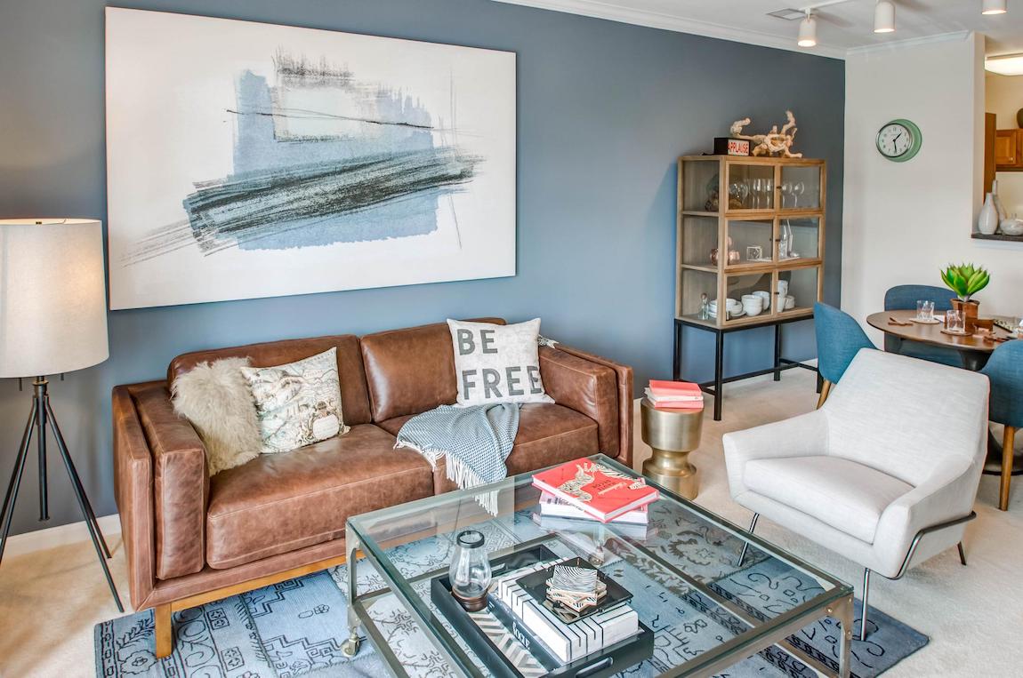 Apartment living room with inviting blue wall and artwork