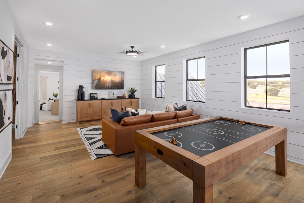 loft space with air hockey table and shiplap walls