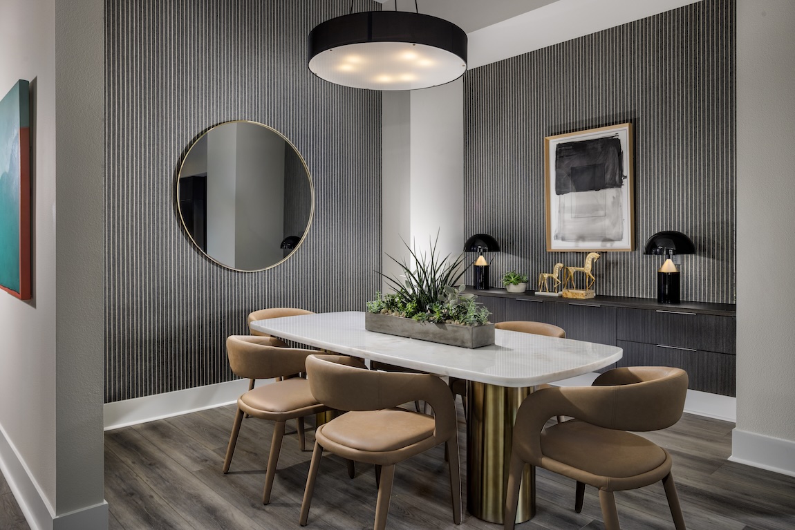 modern dining room with fluted panel walls and statement lighting