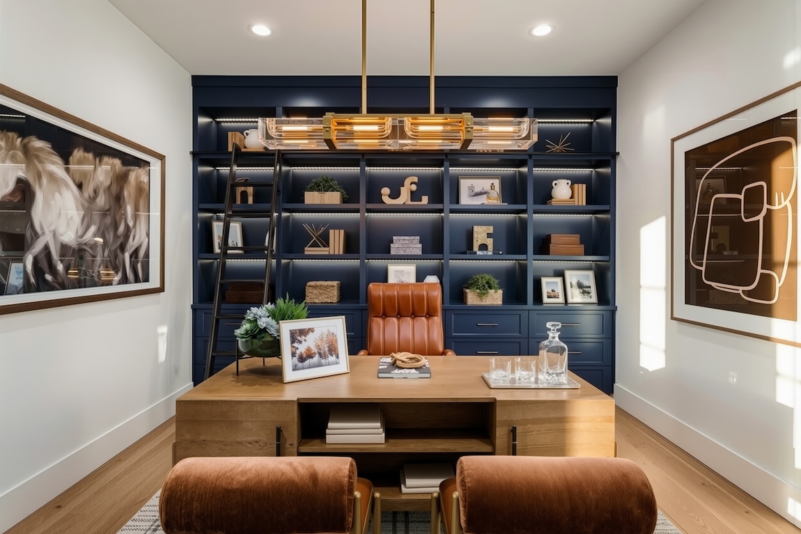 home office with built-in shelving and a large desk
