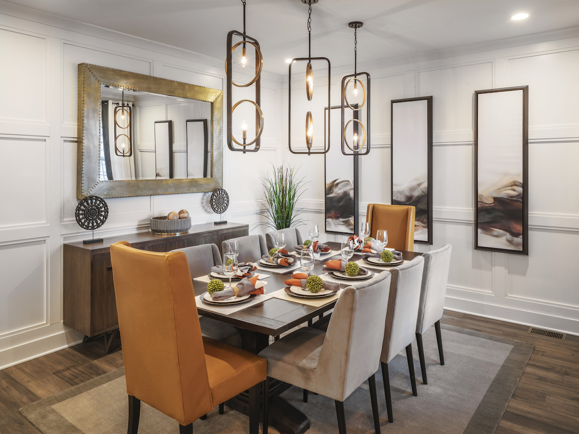 Timeless dining room design featuring mix-and-match chairs and pendant lights