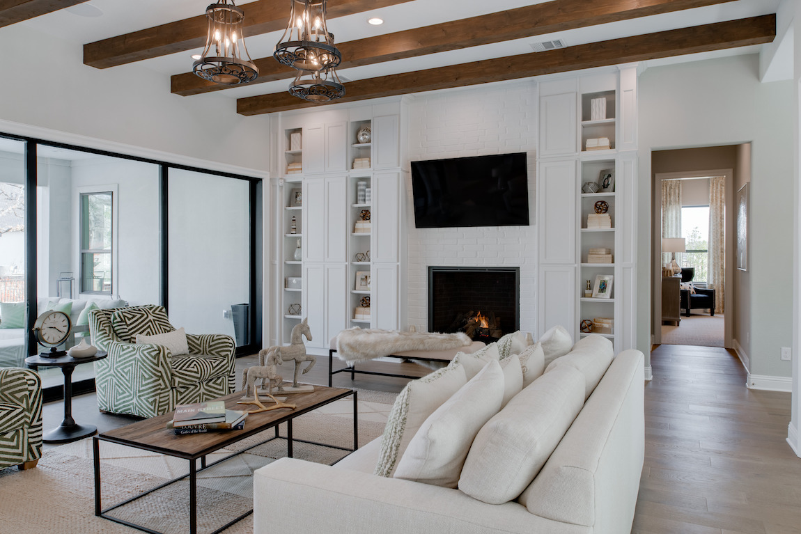 Light toned great room with wood beam ceiling accents