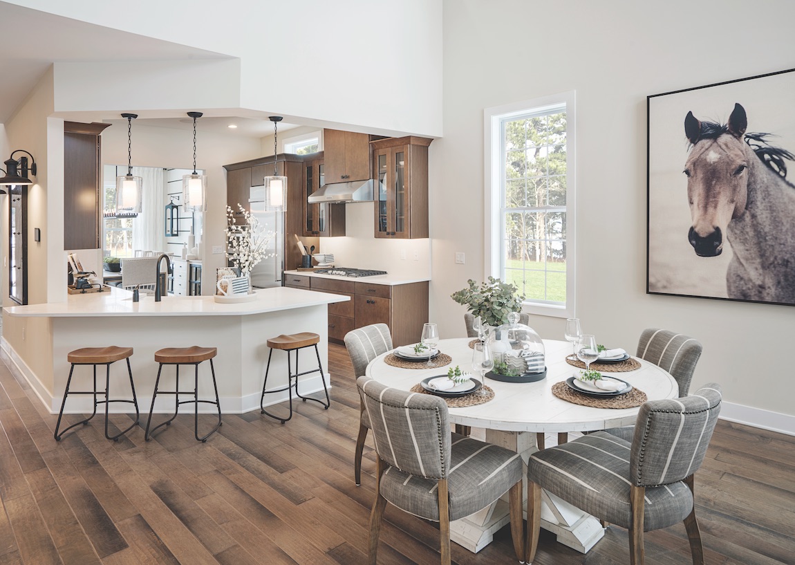 Wooden floor with white round breakfast dining area.