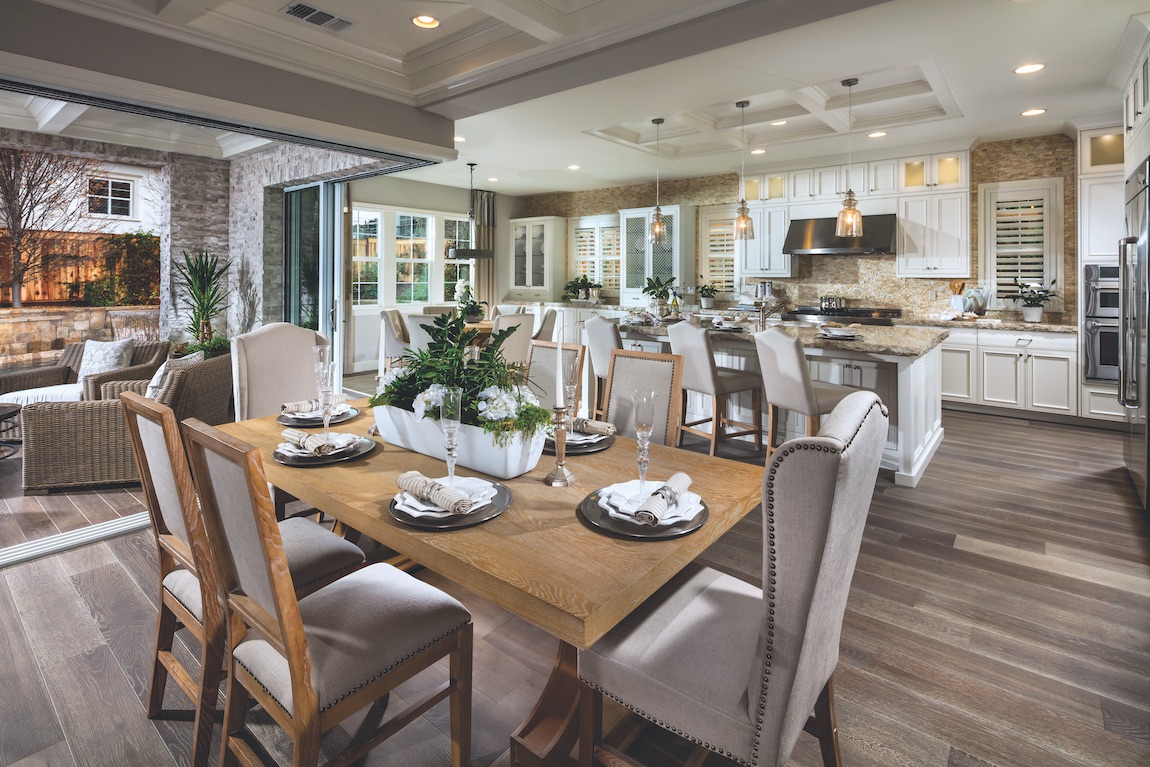 Wooden dining table with tuft chair and hardwood floors.
