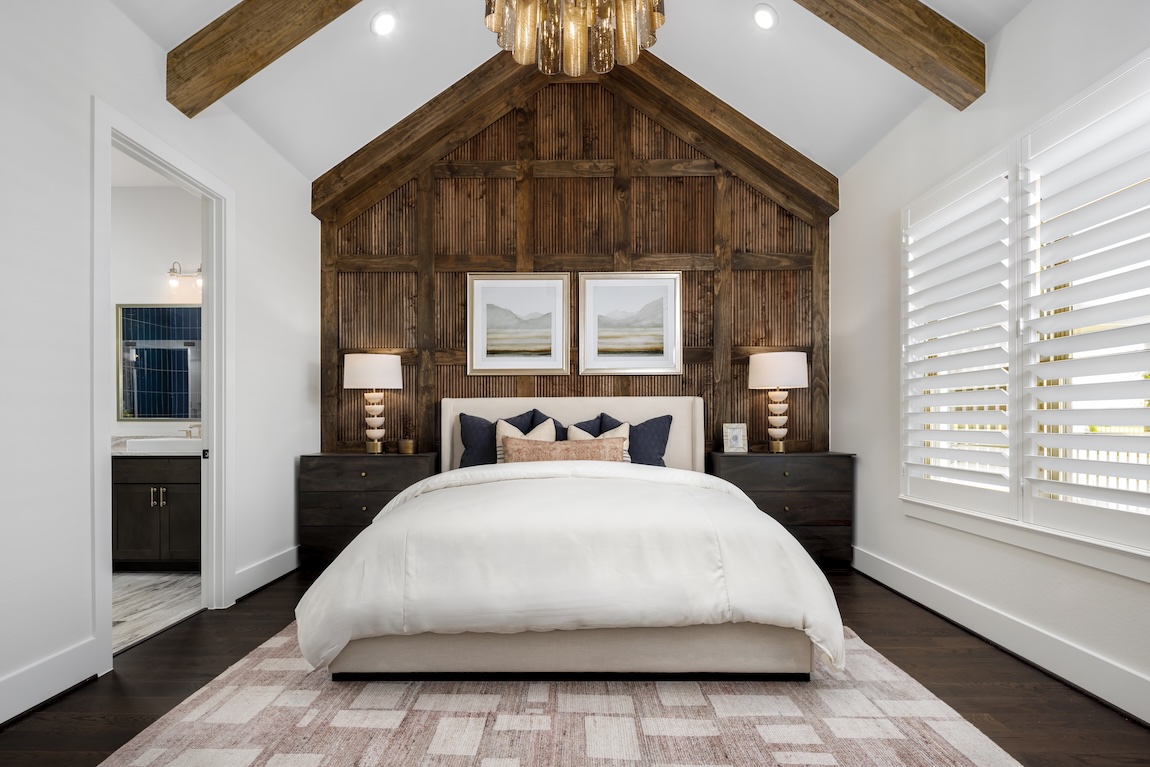 primary bedroom with wooden accent wall