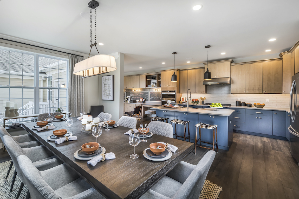 Dining table with blue island in kitchen