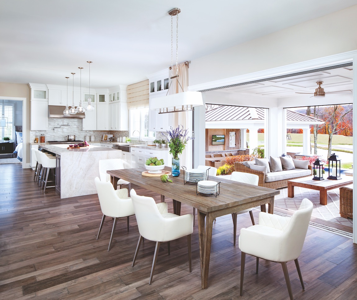 Indoor to outdoor living kitchen area with breakfast area and white island