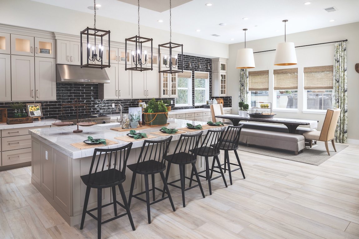 Modern farmhouse kitchen with a long breakfast nook table with benches for seating.