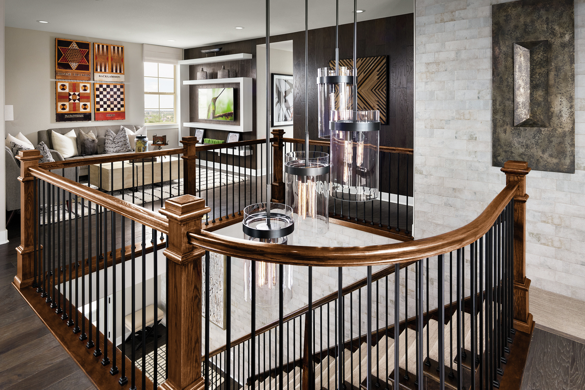View from upstairs loft of staircase with black spindles.