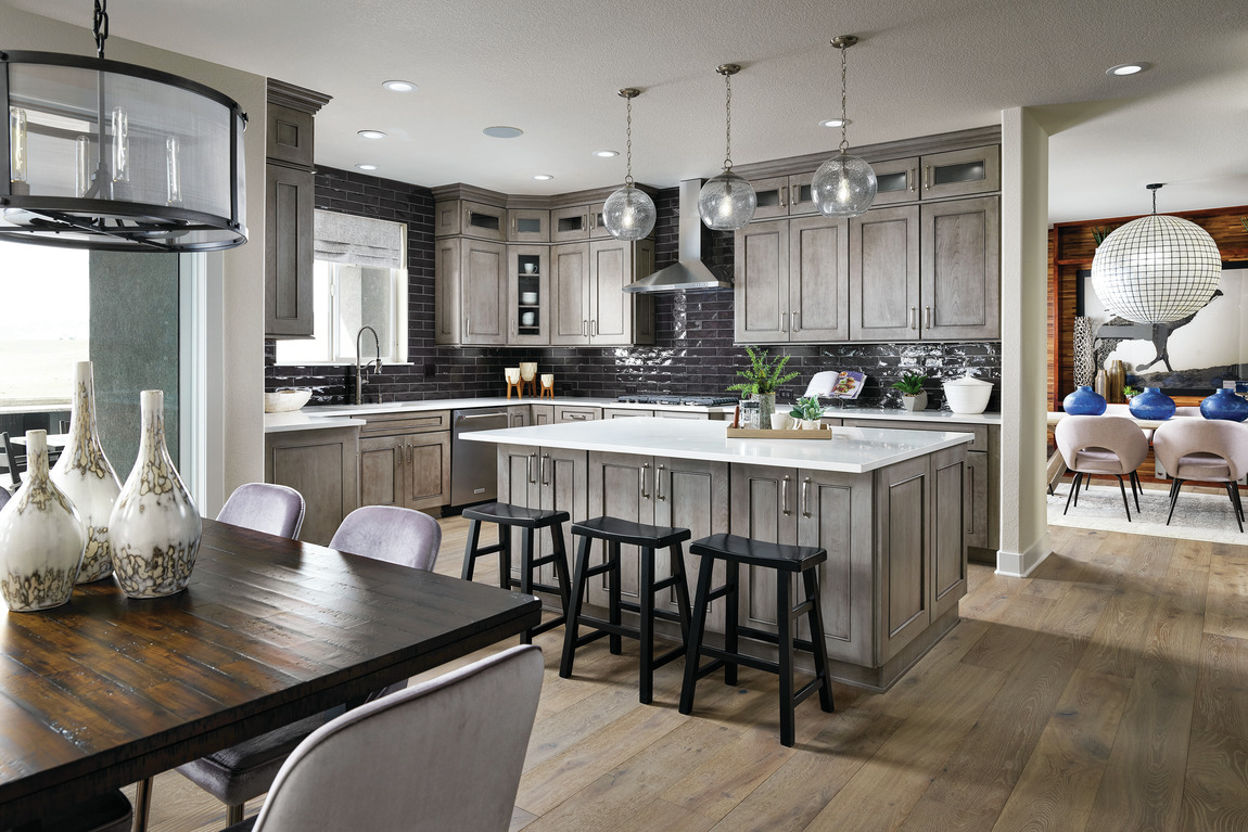 Modern kitchen with industrial decor and black subway tile design.