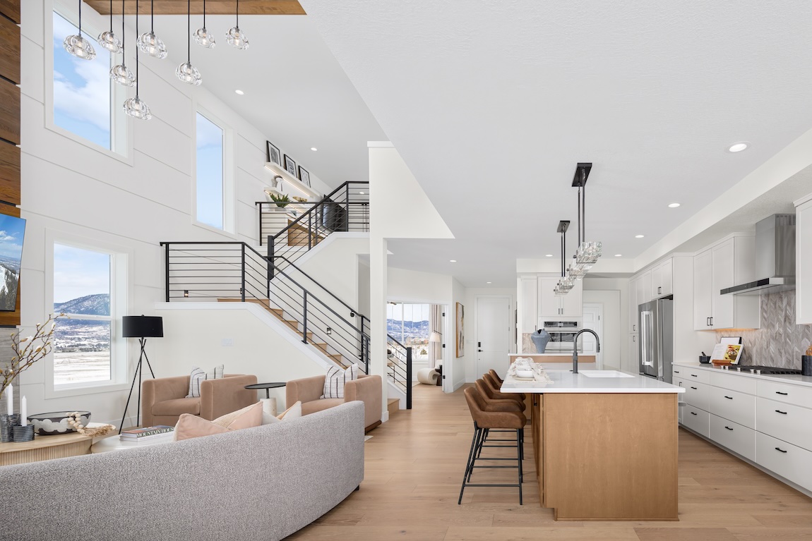 modern kitchen with white cabinets and views of mountains 