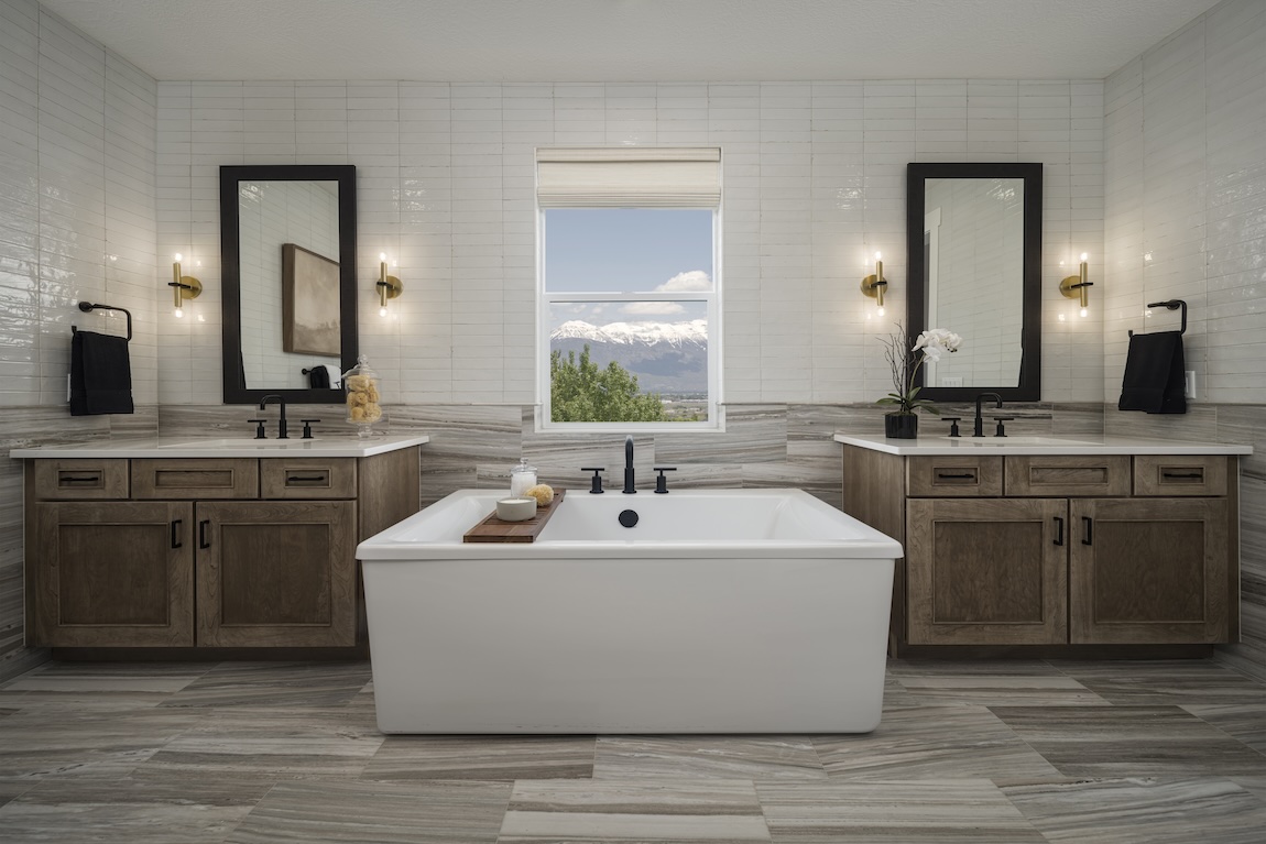 primary bathroom with tub under window looking out at the mountains