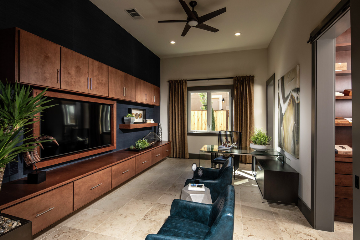 Black ceiling fan with light and 5 blades in entertainment room