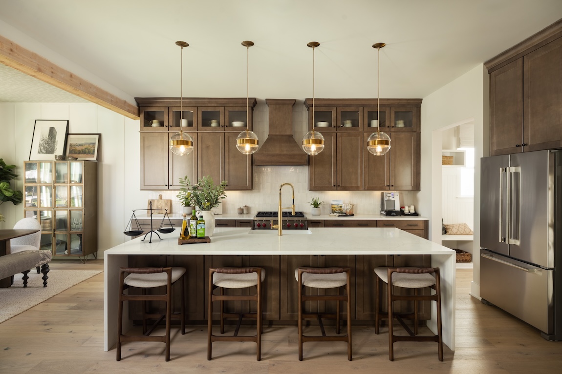 modern kitchen with wood cabinets and a waterfall island