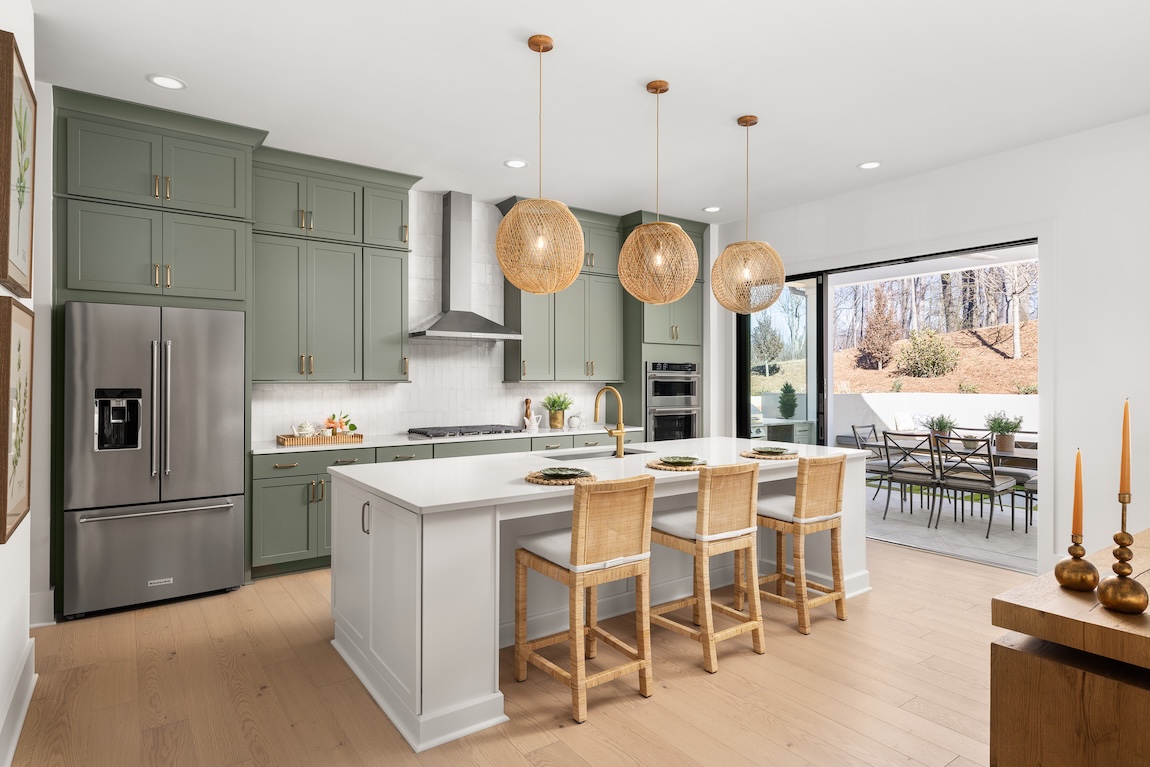 modern kitchen with green cabinets and wood features