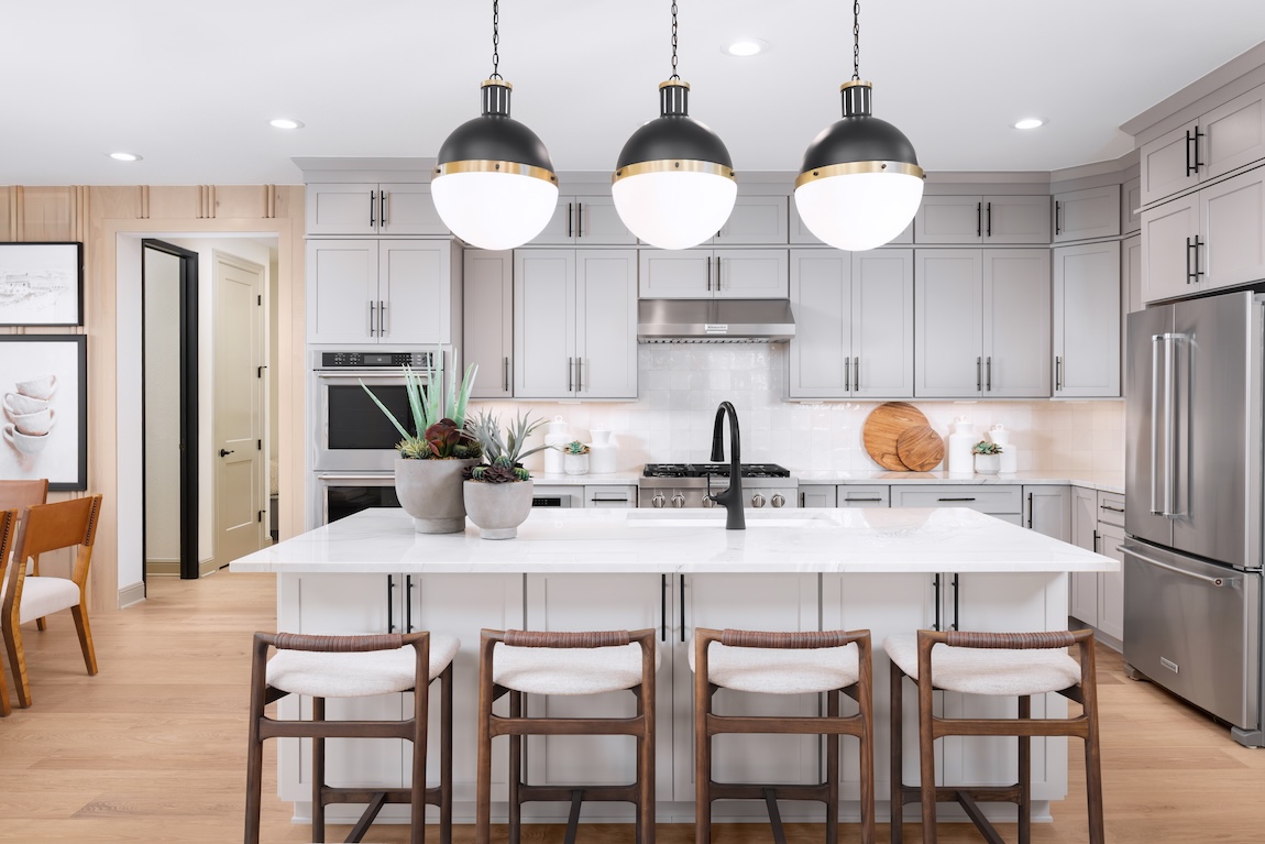kitchen with wooden stools and globe pendant lights