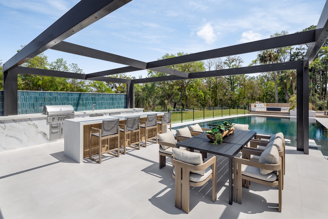 outdoor kitchen space next to the pool