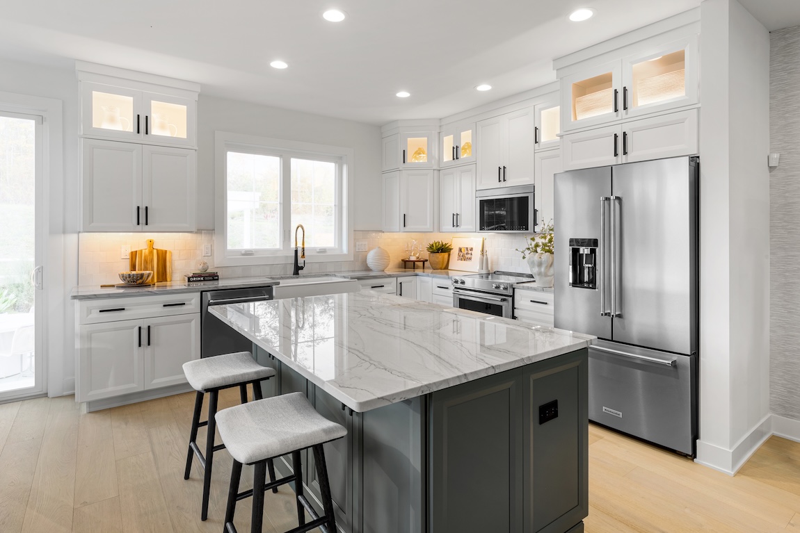 modern kitchen with marble island and two barstools