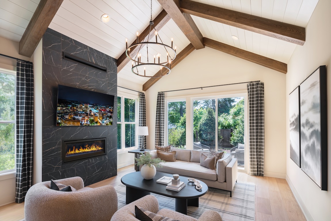 living room with wood beam ceiling and fireplace setting