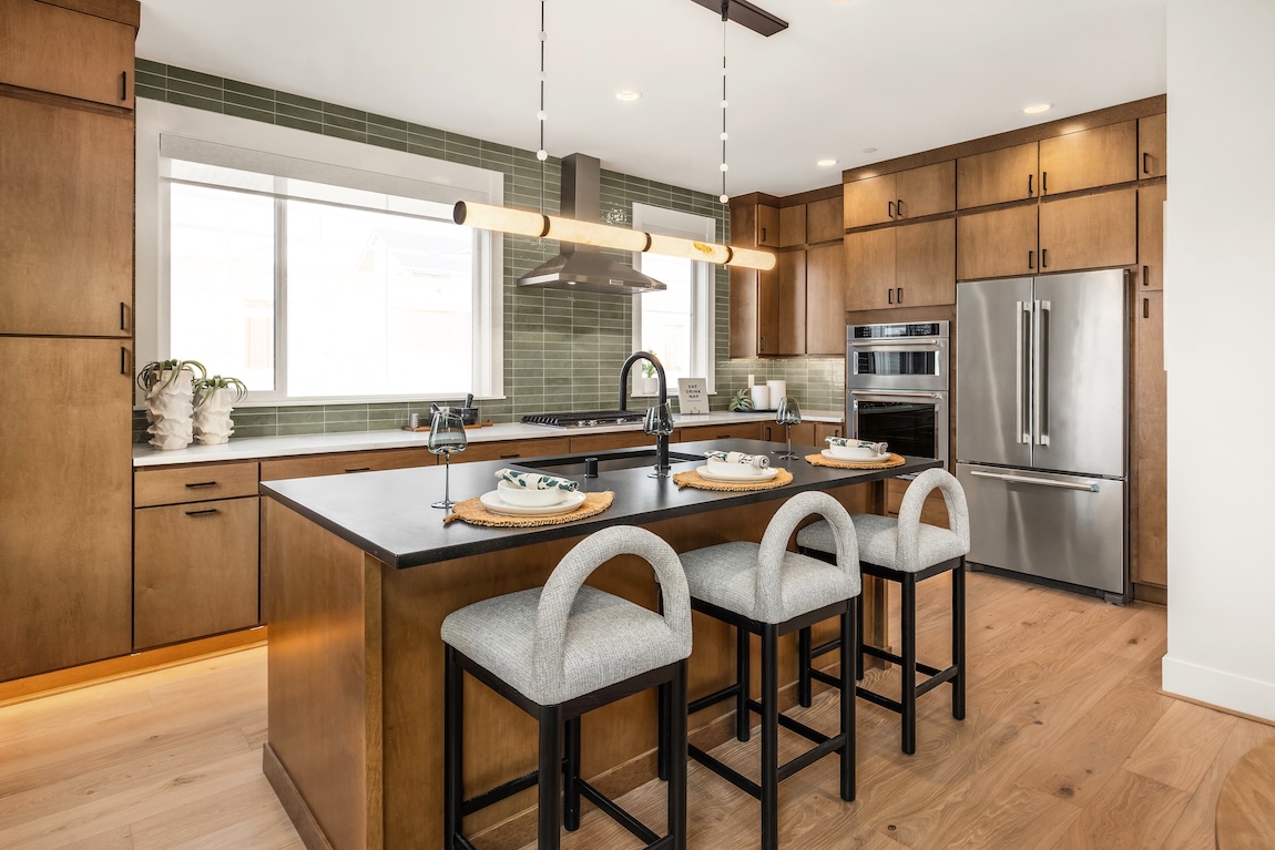 kitchen with green backsplash and wooden cabinets