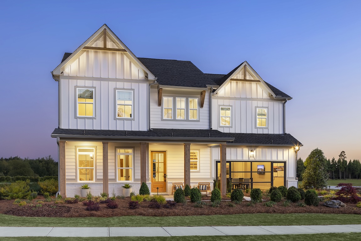 modern farmhouse exterior with wood beams and lighting