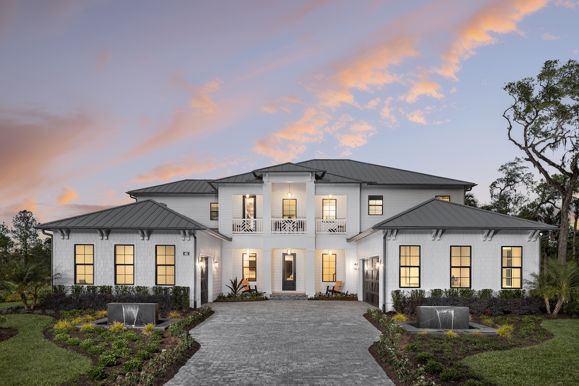 modern exterior with palm trees and beautiful landscaping framing the home