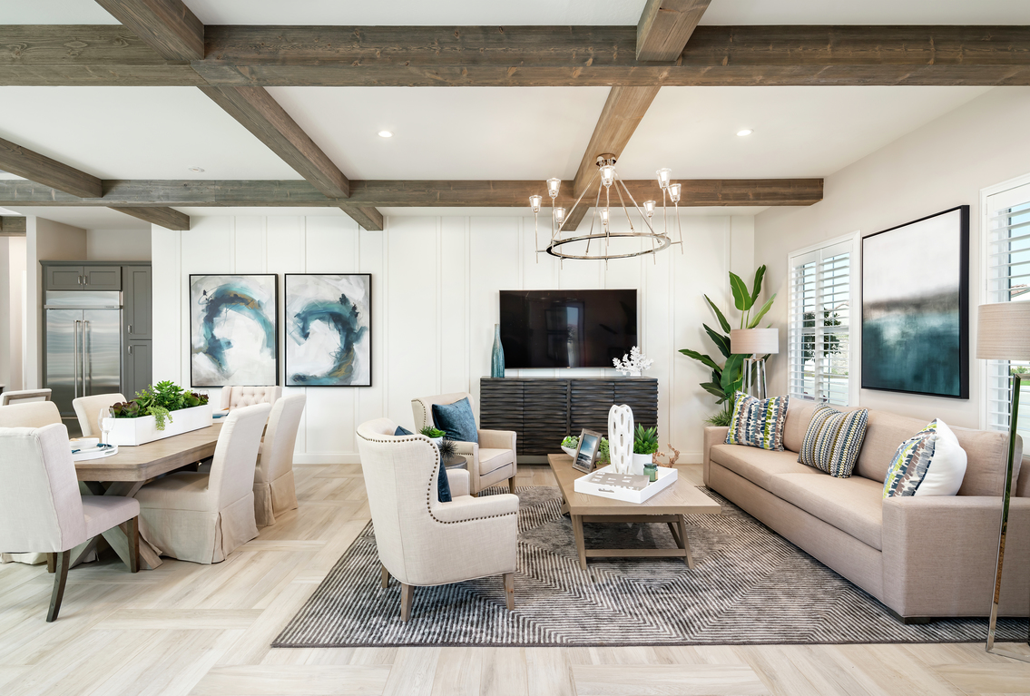 Farmhouse great room with a rustic beam ceiling.
