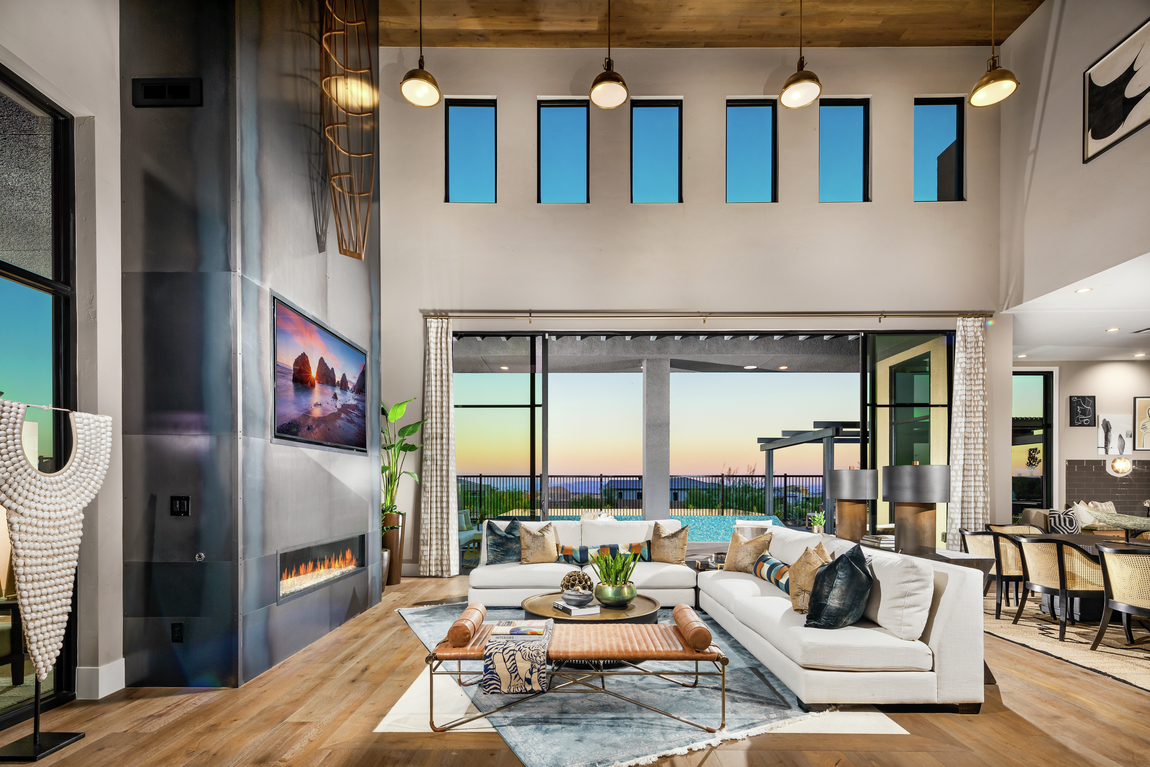 A dimensional fireplace in a large living room with tall ceilings.